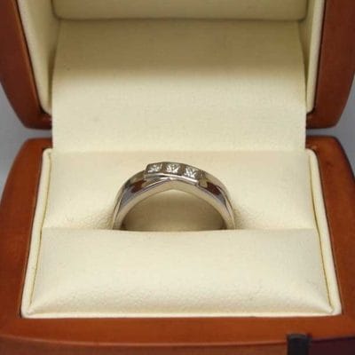 Beautiful palladium bezel set three stone engagement ring