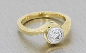 Yellow Gold & Platinum Bezel Set Round Brilliant Crossover Soliatire with emerald and peridot flush set peak stones