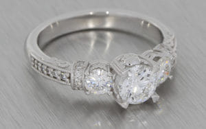 18K white three stone diamond ring with grain set shoulders