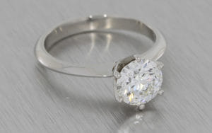 Platinum engagement ring set with a Crafted by Infinity diamond with a hidden emerald